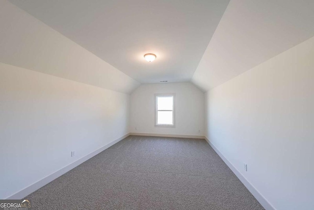 bonus room featuring carpet flooring and lofted ceiling