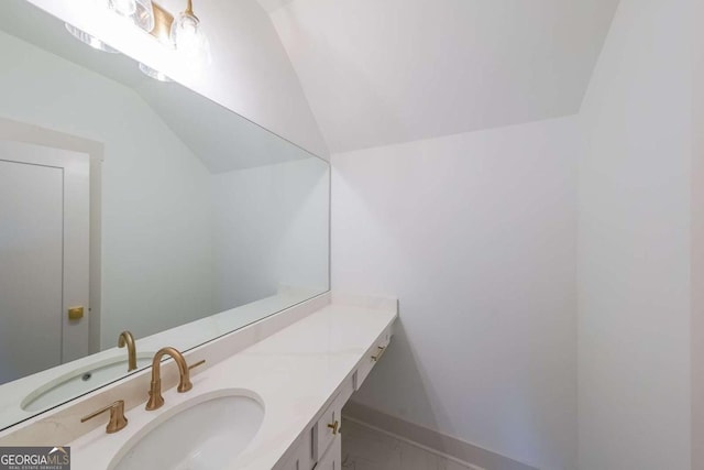 bathroom with vanity and lofted ceiling