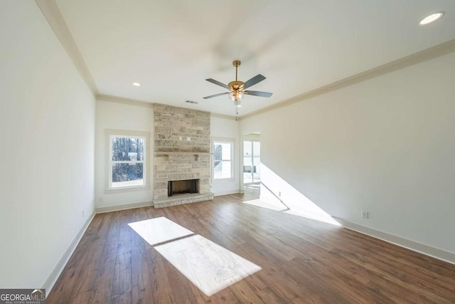 unfurnished living room featuring ceiling fan, dark hardwood / wood-style flooring, ornamental molding, and a fireplace