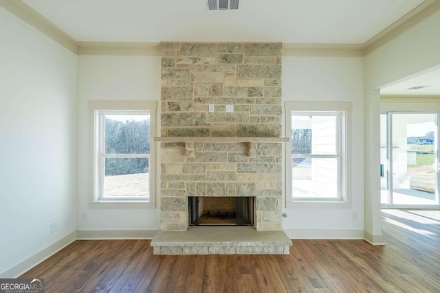 unfurnished living room with a fireplace, hardwood / wood-style floors, and ornamental molding