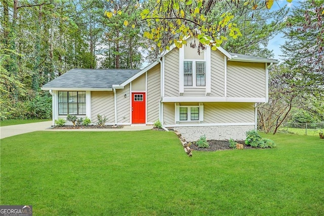 tri-level home with a front yard