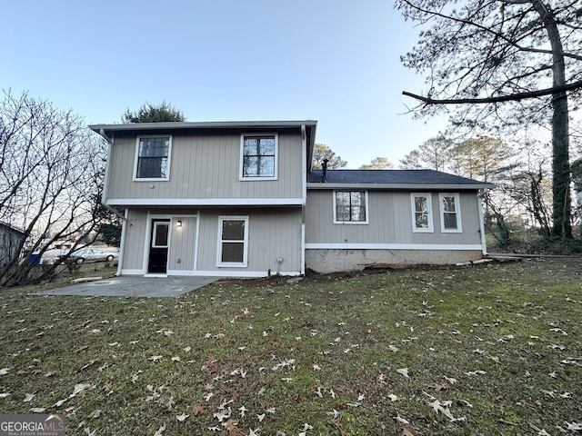 back of house featuring a yard and a patio