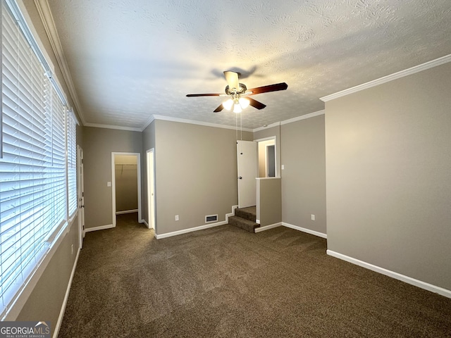 unfurnished bedroom featuring a spacious closet, a closet, ceiling fan, and a textured ceiling