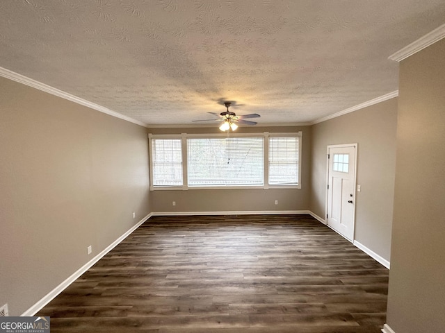 empty room with dark hardwood / wood-style floors, ceiling fan, ornamental molding, and a textured ceiling