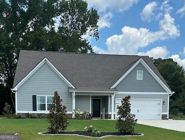 craftsman-style home with a front yard and a garage