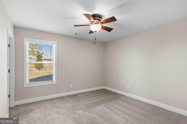 unfurnished room with ceiling fan and light colored carpet