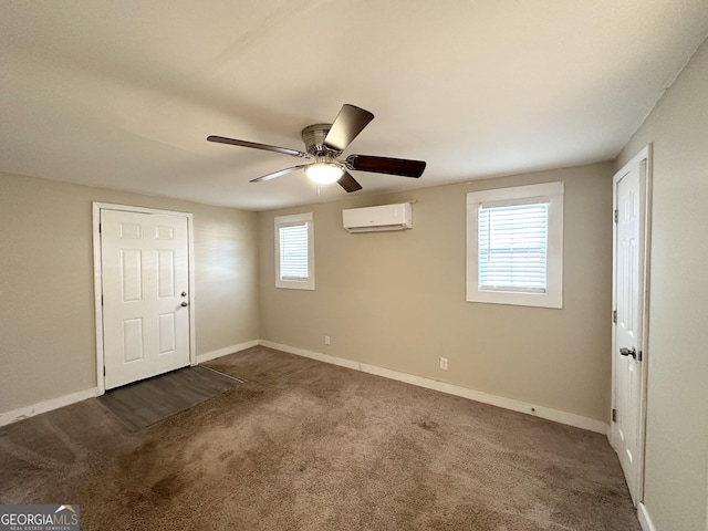 spare room featuring a wall mounted air conditioner, plenty of natural light, and carpet flooring