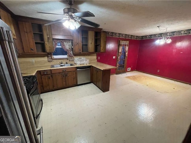 kitchen featuring sink, ceiling fan with notable chandelier, a textured ceiling, and appliances with stainless steel finishes