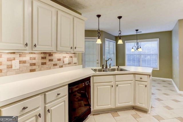 kitchen with pendant lighting, backsplash, sink, black dishwasher, and kitchen peninsula