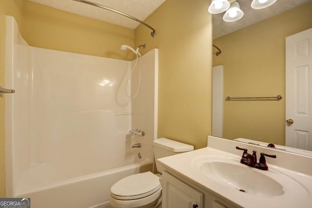 full bathroom featuring vanity, toilet, a textured ceiling, and bathtub / shower combination