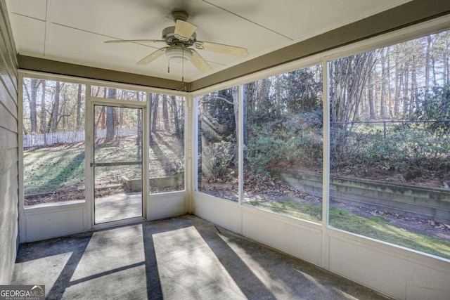 unfurnished sunroom featuring ceiling fan