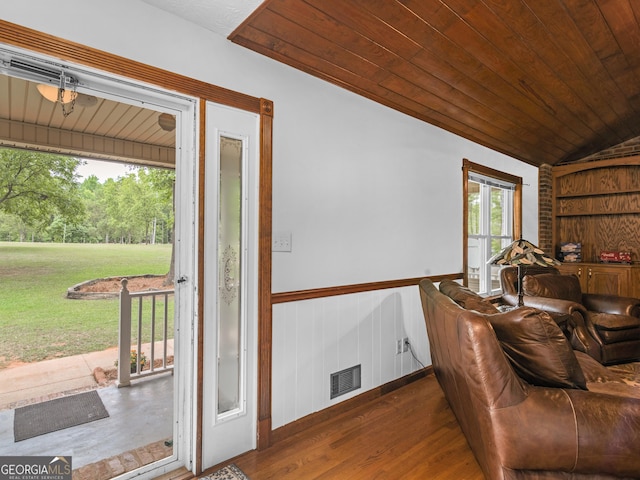 interior space with wood walls, wood ceiling, dark wood-type flooring, and vaulted ceiling