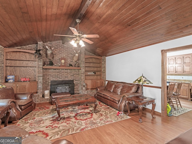 living room with built in shelves, ceiling fan, wooden ceiling, vaulted ceiling, and light wood-type flooring