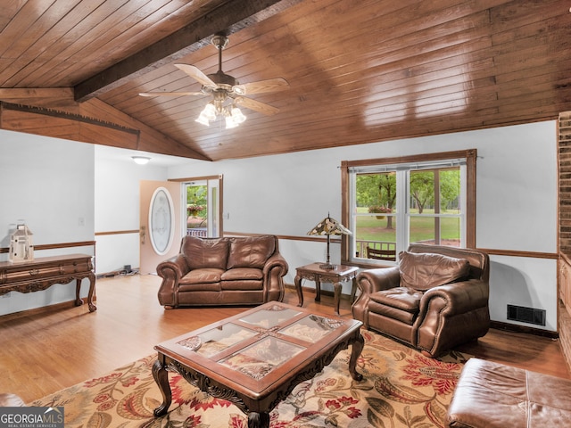 living room with vaulted ceiling with beams, ceiling fan, wood ceiling, and light wood-type flooring