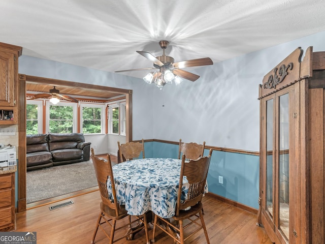 dining room featuring light hardwood / wood-style floors and ceiling fan