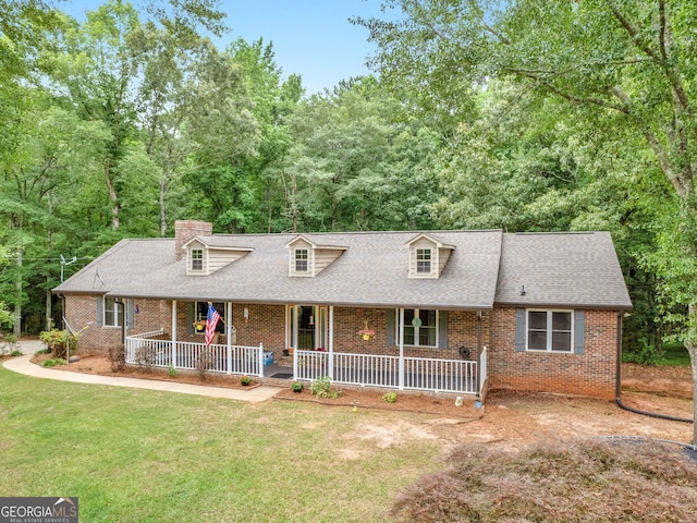 cape cod-style house with covered porch and a front lawn