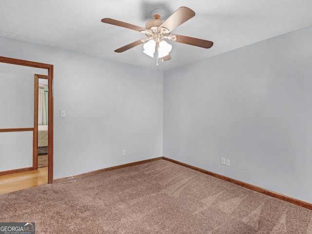 empty room with ceiling fan and carpet floors