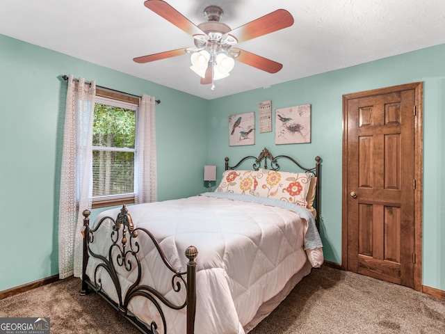 bedroom featuring ceiling fan and carpet