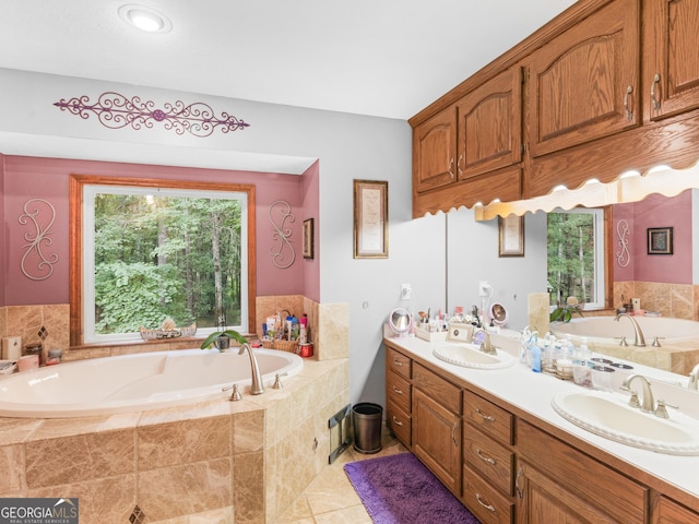 bathroom featuring tiled bath, tile patterned flooring, and vanity