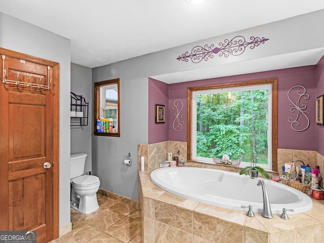 bathroom with a relaxing tiled tub and toilet