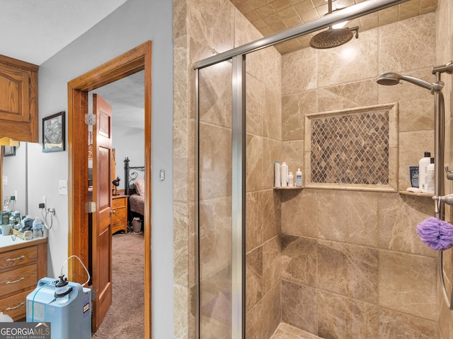 bathroom featuring vanity and a shower with shower door