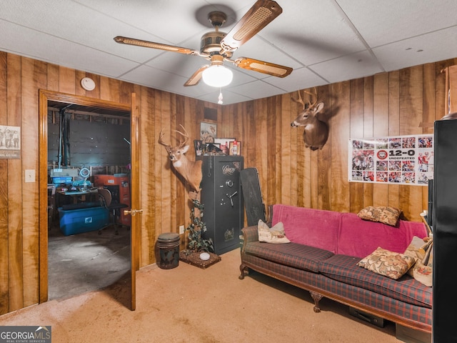 living room featuring carpet flooring and a paneled ceiling