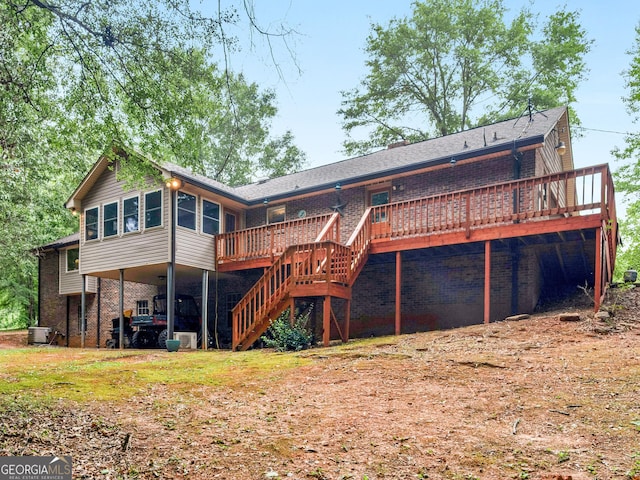 rear view of house with cooling unit and a wooden deck