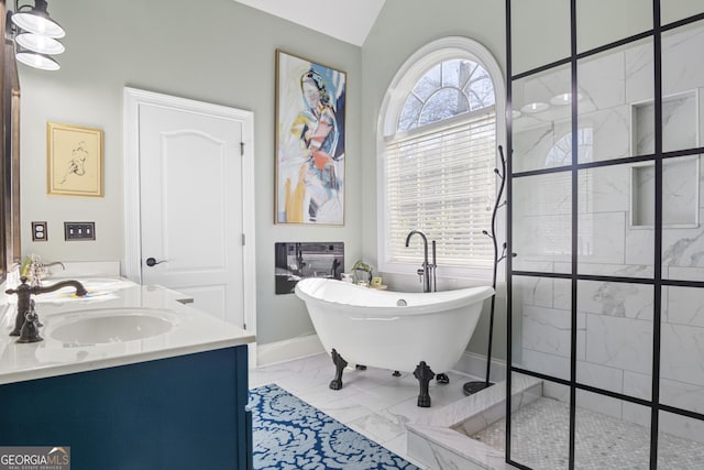 bathroom with vanity, a bath, and vaulted ceiling