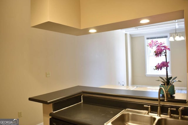 kitchen featuring an inviting chandelier, plenty of natural light, and sink