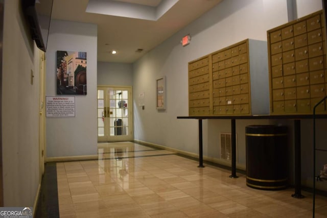 interior space with light tile patterned floors and a mail area