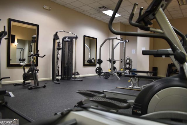 exercise room featuring a paneled ceiling