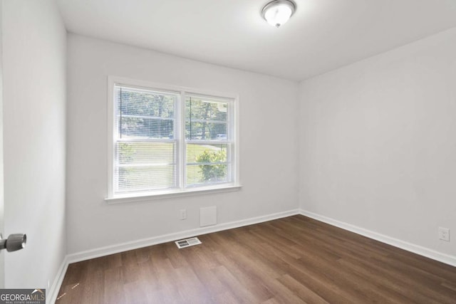 empty room featuring wood-type flooring