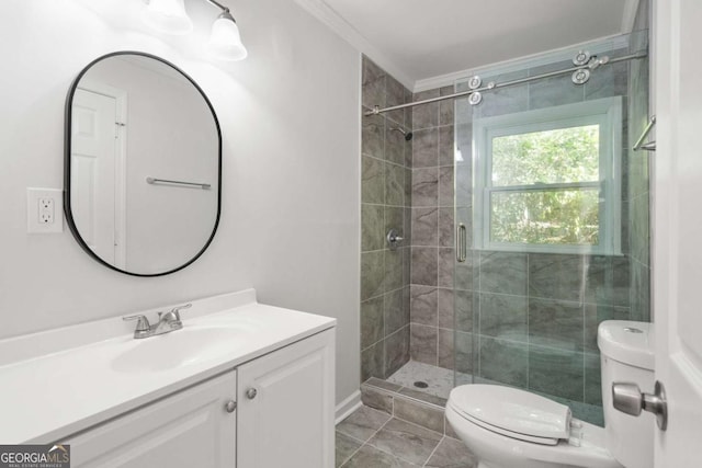 bathroom with vanity, toilet, a shower with shower door, and ornamental molding