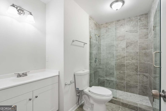 bathroom with vanity, toilet, and an enclosed shower