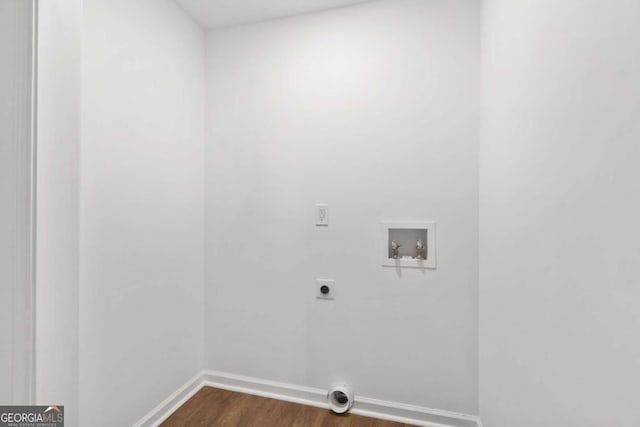 clothes washing area with hookup for an electric dryer, hookup for a washing machine, and dark hardwood / wood-style flooring