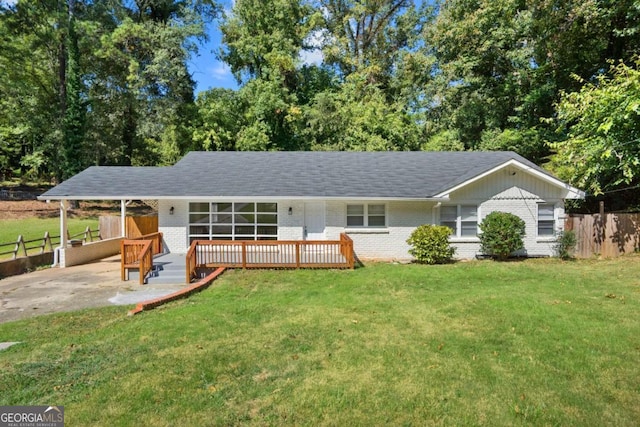 view of front of home with a carport and a front lawn