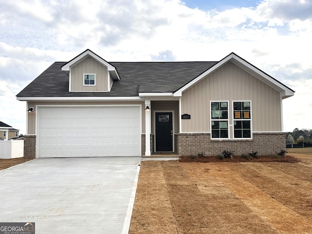 view of front of house featuring concrete driveway and brick siding