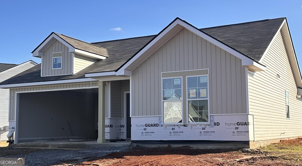 view of front of house with a garage and a front lawn