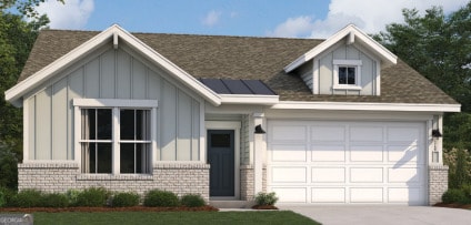 view of front of house with a garage and a front lawn