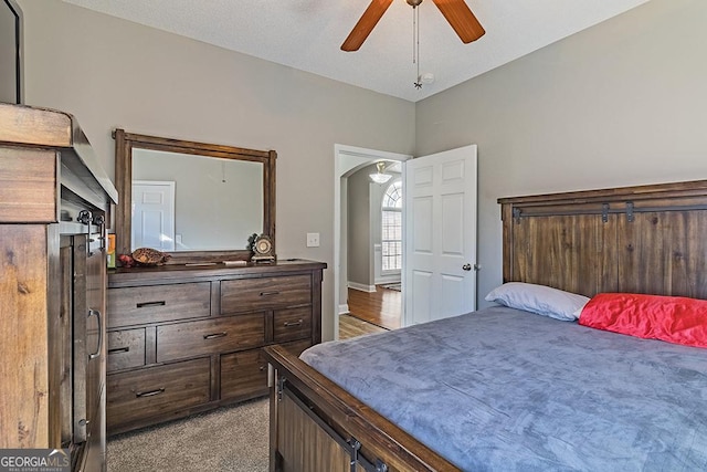 bedroom with light carpet and ceiling fan