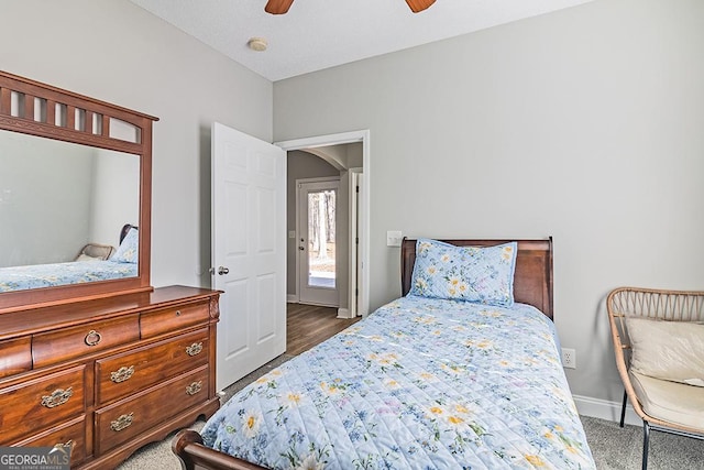 bedroom with ceiling fan and dark carpet