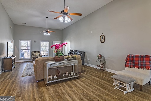 living room featuring ceiling fan, dark wood-type flooring, and high vaulted ceiling