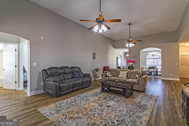 living room with ceiling fan, high vaulted ceiling, and dark wood-type flooring