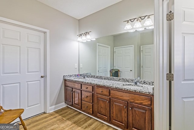 bathroom with vanity and hardwood / wood-style flooring