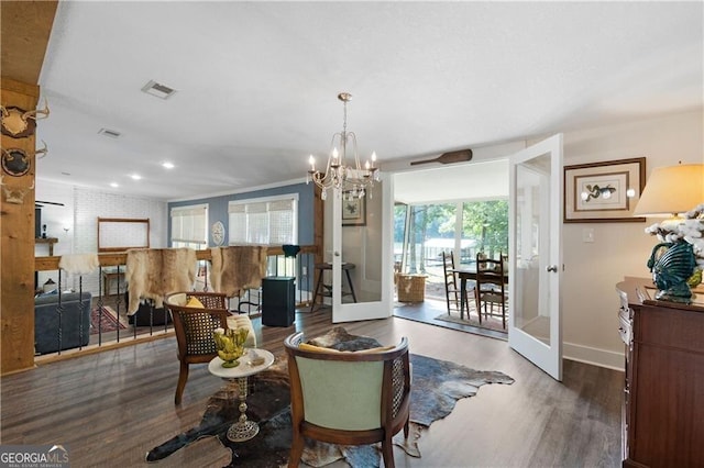 living room featuring french doors, dark wood-type flooring, and a notable chandelier