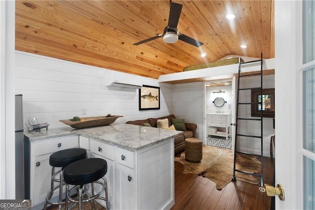 kitchen with white cabinets, lofted ceiling, light stone counters, and wood ceiling