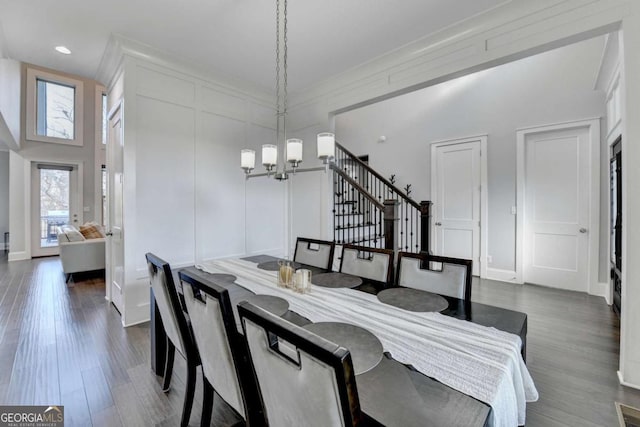 dining space featuring dark hardwood / wood-style flooring and a chandelier