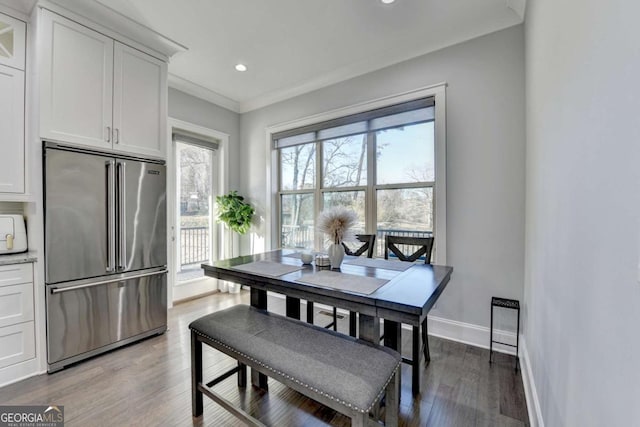 dining area featuring crown molding, plenty of natural light, and hardwood / wood-style floors