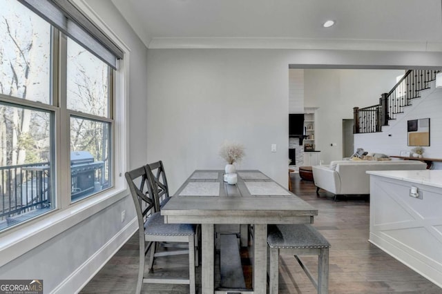 dining area featuring dark hardwood / wood-style floors and crown molding