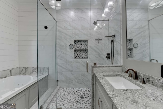 bathroom featuring vanity and shower with separate bathtub